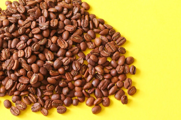 Coffee beans as a background isolated on yellow background.