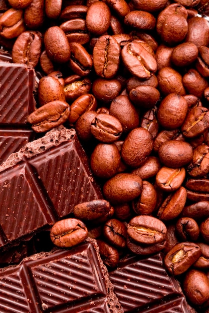 Coffee beans and black chocolate background