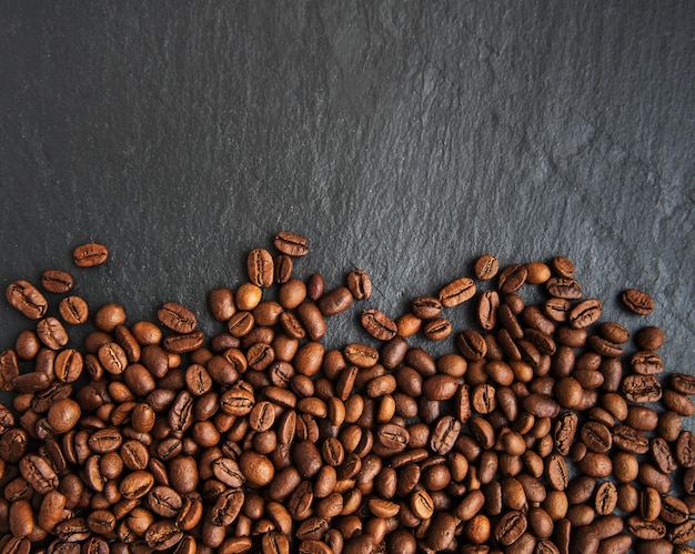 Coffee beans on a black stone background