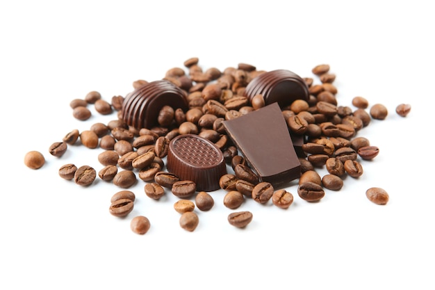 coffee beans and chocolate on white surface isolated close up