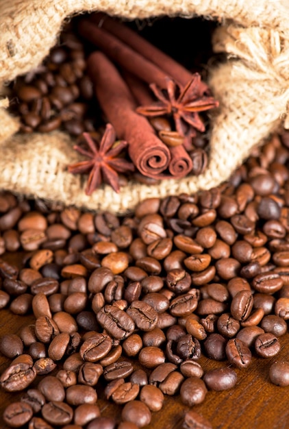 Coffee beans cinnamon sticks and star anise dark background