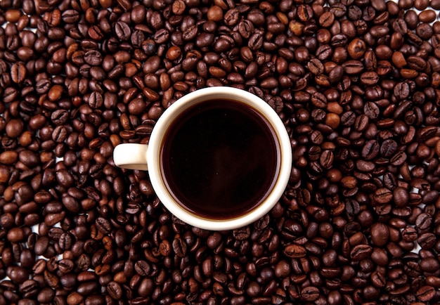 Coffee beans in coffee cup isolated on white