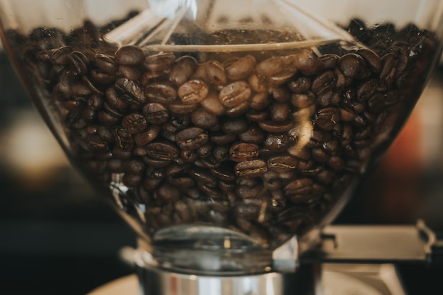 Coffee beans in coffee machine with vintage color tone.