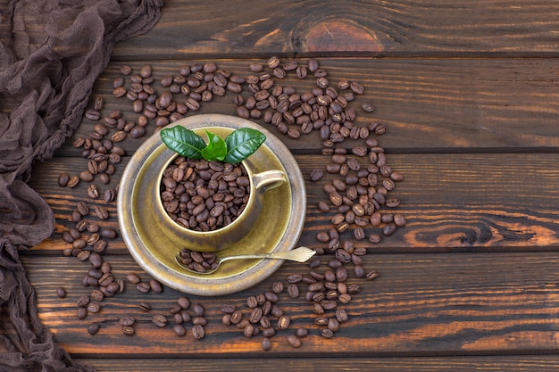 coffee beans in a cup on a wooden table