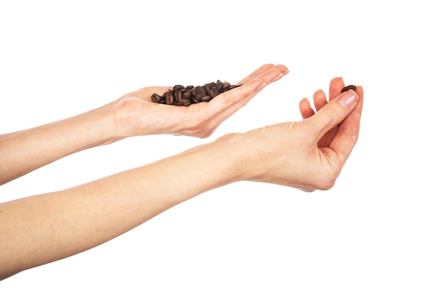 Coffee beans in female hands isolated on white background