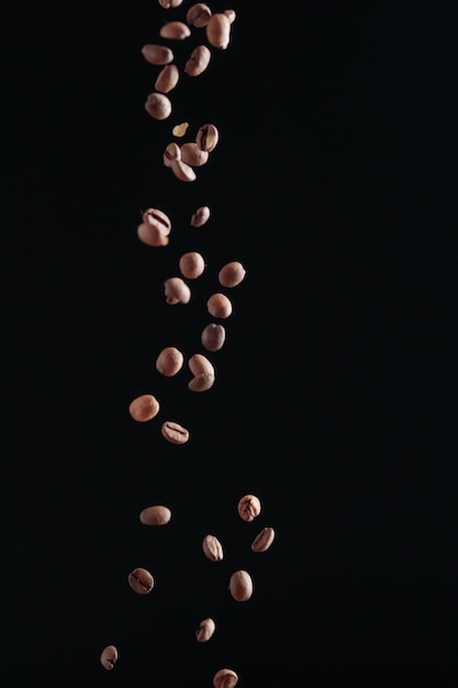 Coffee beans in flight on a dark background