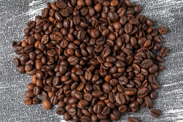 Coffee beans on a gray background made of fabric