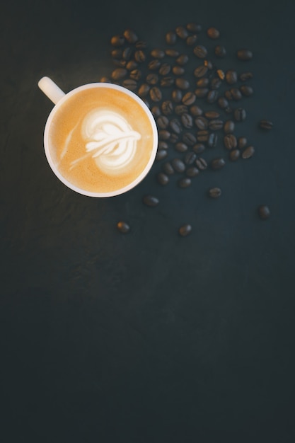 Coffee beans and ground powder on black background. Top view with copy space