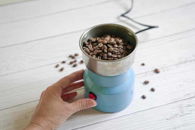 Coffee beans inside an electrical grinder