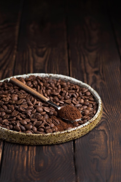 Coffee beans on a plate A spoon with ground coffee Arabica Macro photography in food photography