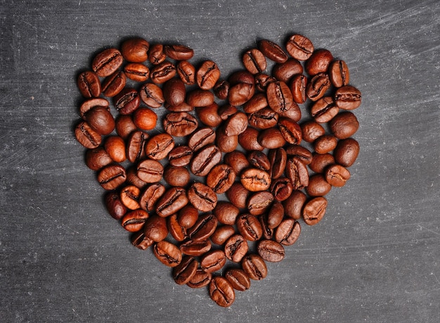 Coffee beans shaped as a heart we love coffee background