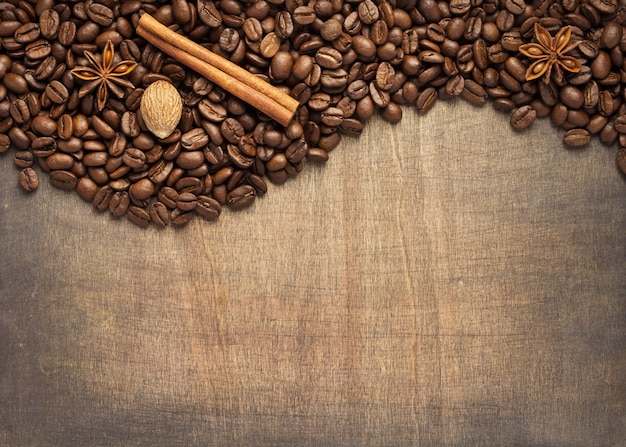 Coffee beans and spices on wood