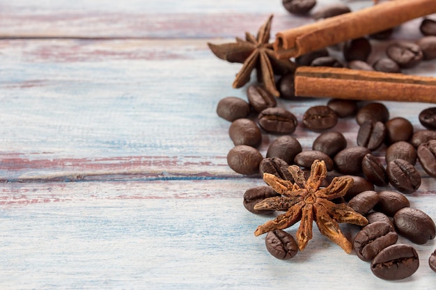 Coffee beans and spices on wooden table