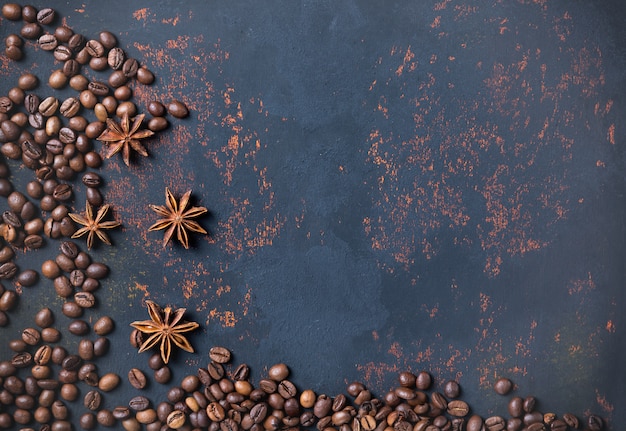 Coffee beans with spices anise on rusty stone surface background