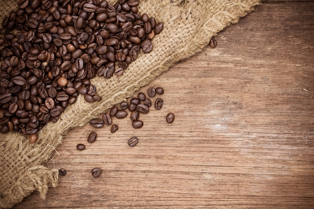 Coffee beans on wood background