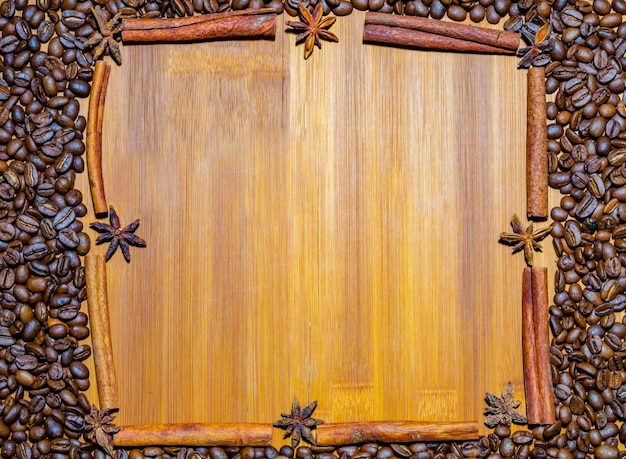 Coffee beans on a wooden background with a place to copy.