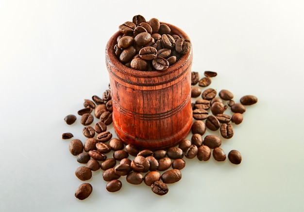 Coffee beans in a wooden barrel isolated