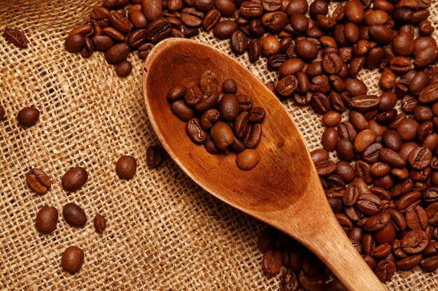 Coffee beans and wooden spoon