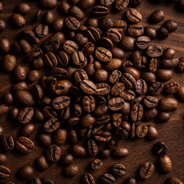 Coffee beans on a wooden table with the word coffee on it