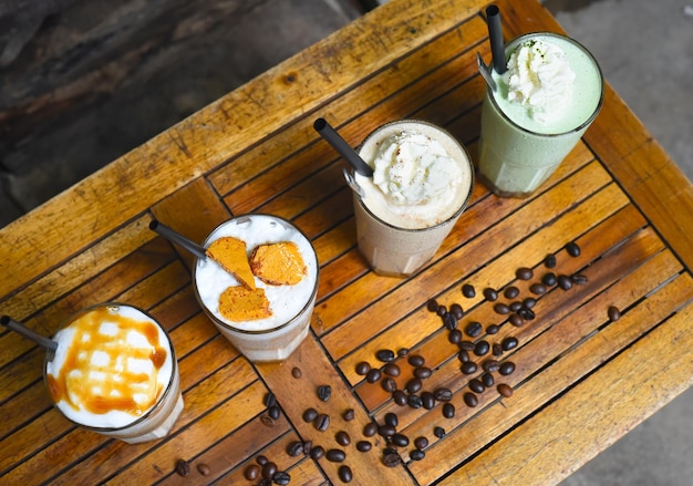 Coffee beverages with coffee beans on wooden table in a coffee shop