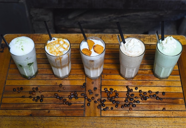 Coffee beverages with coffee beans on wooden table in a coffee shop