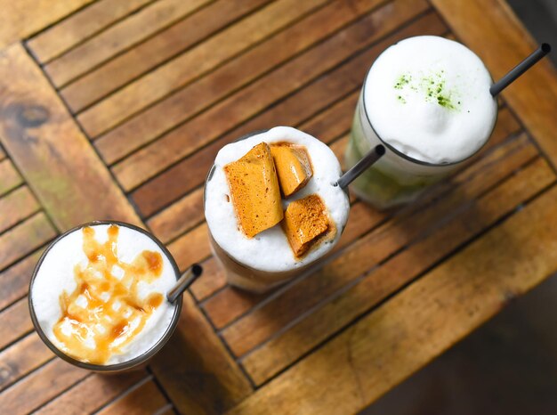 Coffee beverages with coffee beans on wooden table in a coffee shop