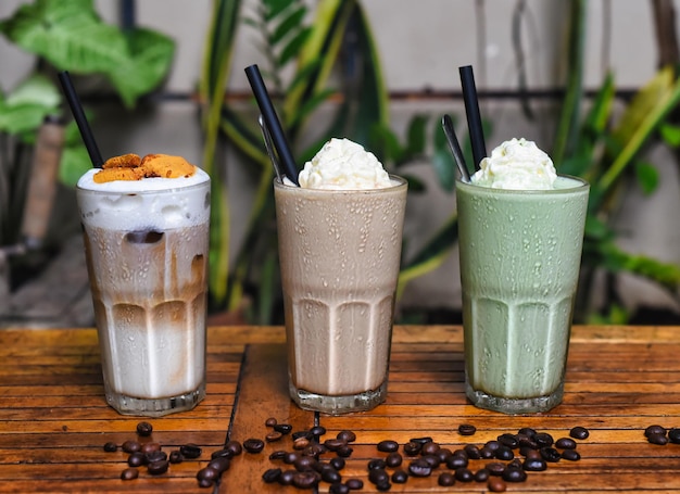 Coffee beverages with coffee beans on wooden table in a coffee shop