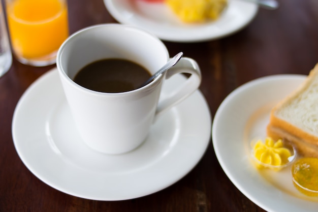 Coffee and breakfast set on wooden table