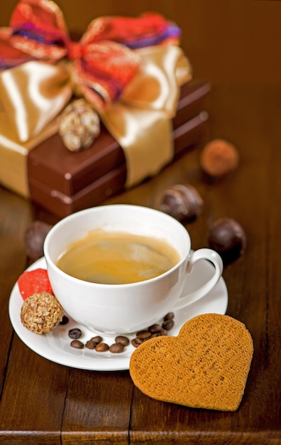 Coffee and cake a cup of coffee and candy on vintage wooden background