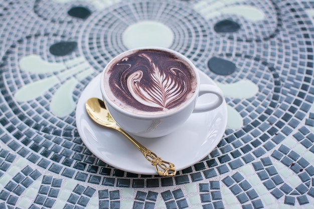 Coffee cappuccino on table with nature background