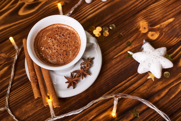 Coffee and cookies on the brown wooden table at Christmas