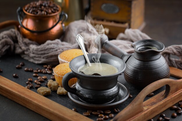 Coffee in a cup on a background of coffee beans on an old background