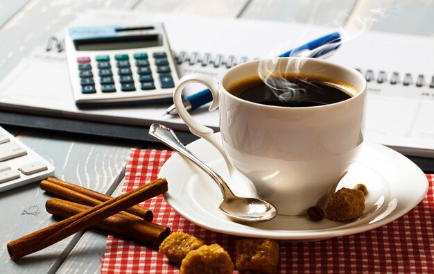 Coffee in a cup on the background of items for doing business