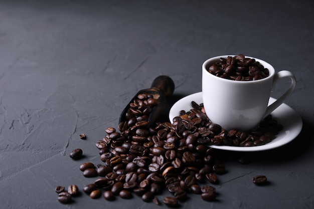 Coffee cup and beans on old grey kitchen beton , rock table. with copyspace