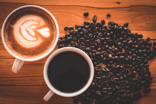 Coffee cup and beans on old kitchen table 