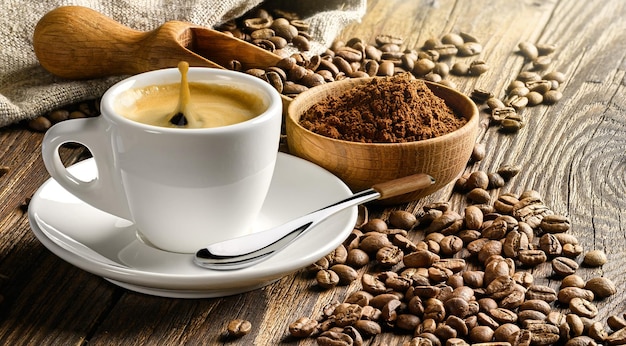 Coffee cup and beans on old wooden table