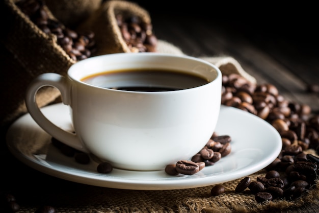 Coffee cup and beans on a rustic background. 