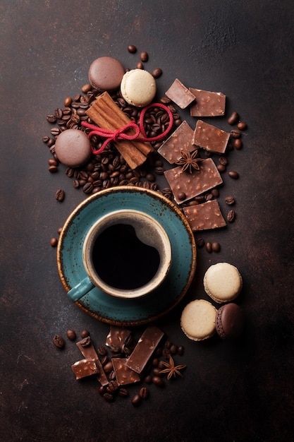 Coffee cup chocolate and macaroons on old kitchen table