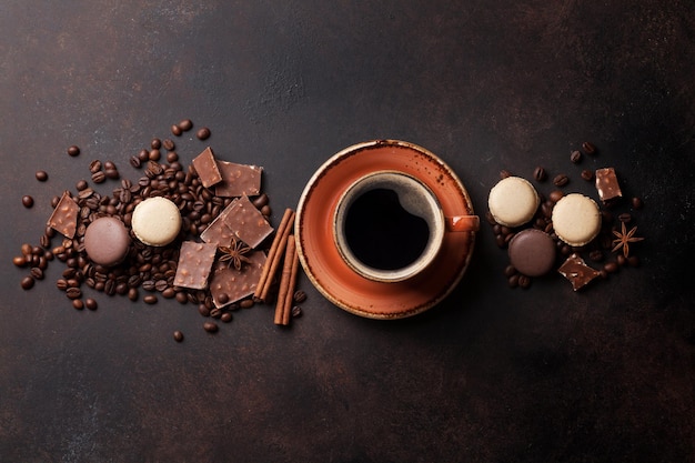 Coffee cup chocolate and macaroons on old kitchen table