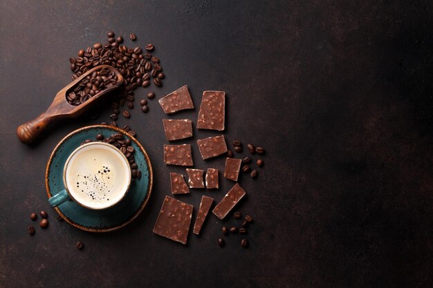 Coffee cup and chocolate on old kitchen table