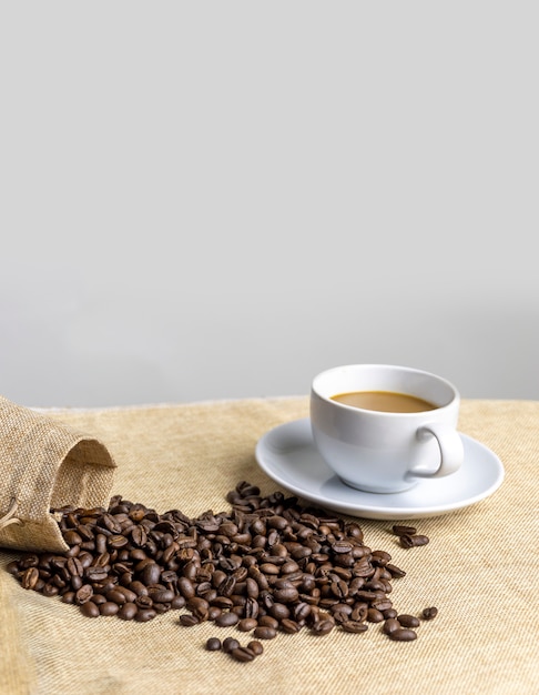 Coffee cup and coffee beans on table