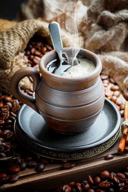 Coffee in a cup on coffee beans.