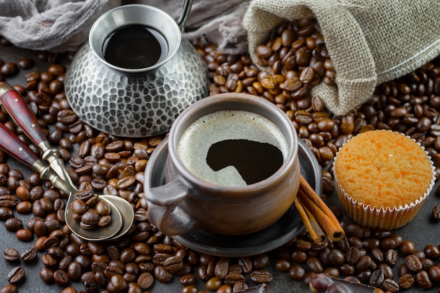 Coffee in a cup on coffee beans