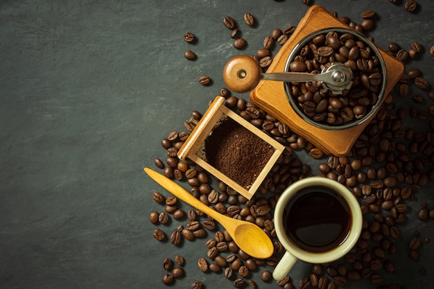 Coffee cup and coffee equipment on black cement floor.