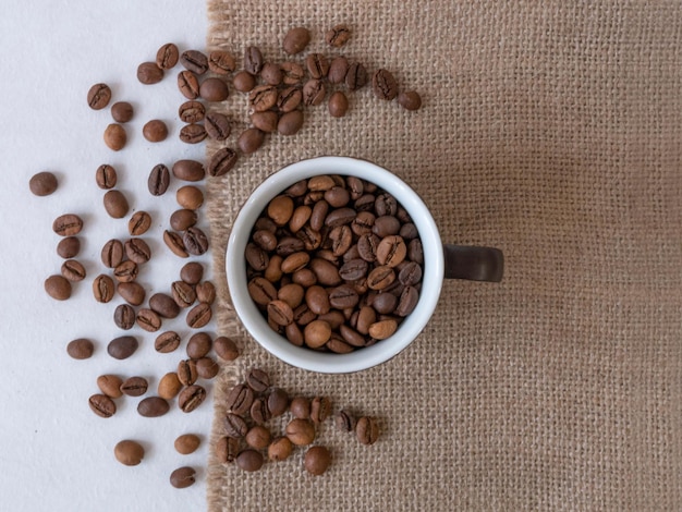 Coffee cup and grain on the canvas cloth from above