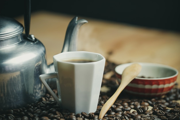 Coffee cup and hot pot roasted coffee beans.