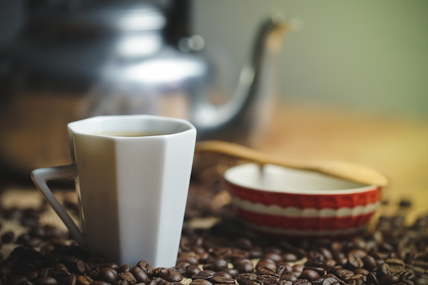 Coffee cup and hot pot roasted coffee beans.