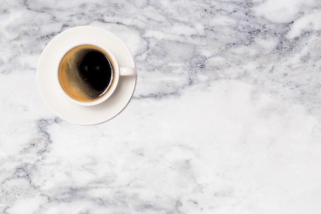 Coffee cup on marble table top view.