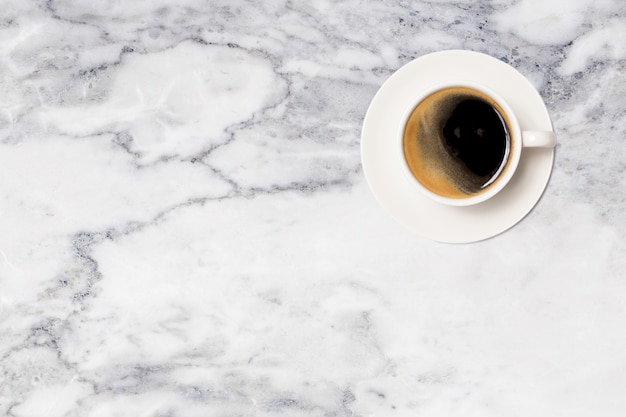 Coffee cup on marble table top view.