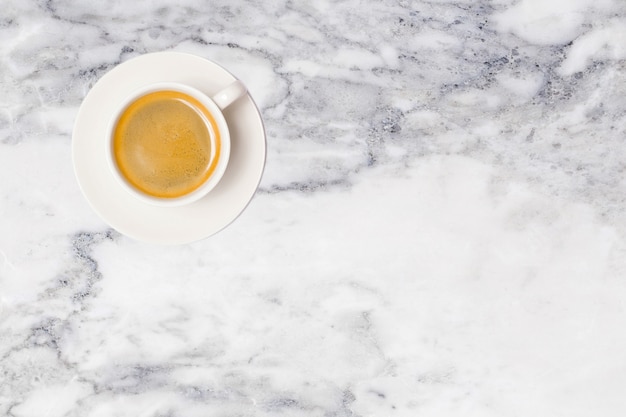 Coffee cup on marble table top view.